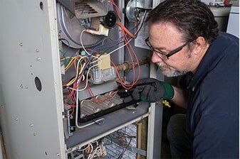 Open furnace cabinet during a heating repair