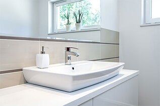 Vessel sink and chrome faucet on a bathroom vanity