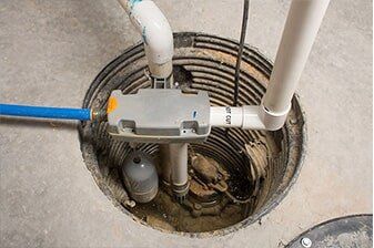 Sump pump in a concrete basin with discharge piping
